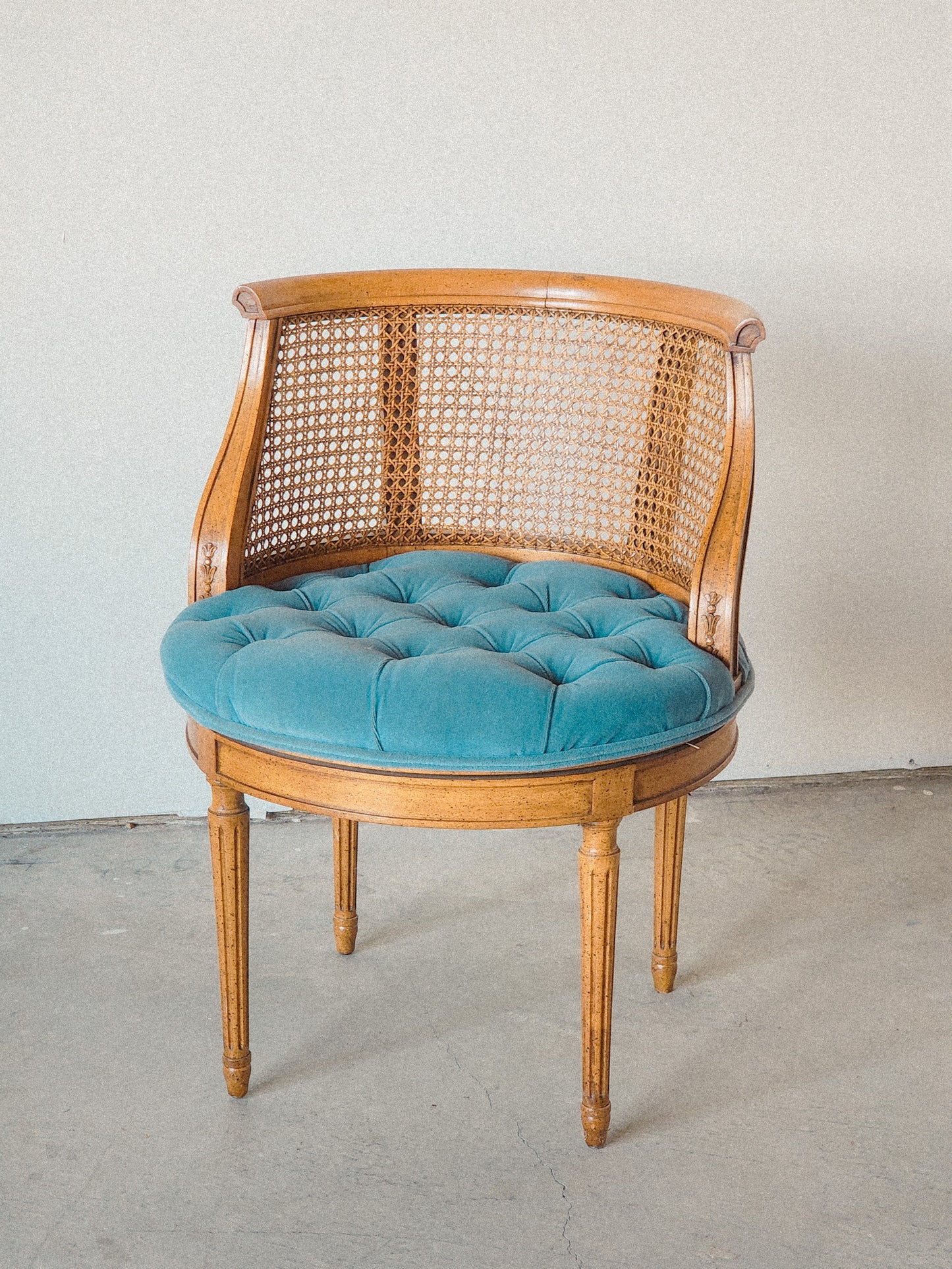 Vtg Swiveling Tufted Blue Caned Chair