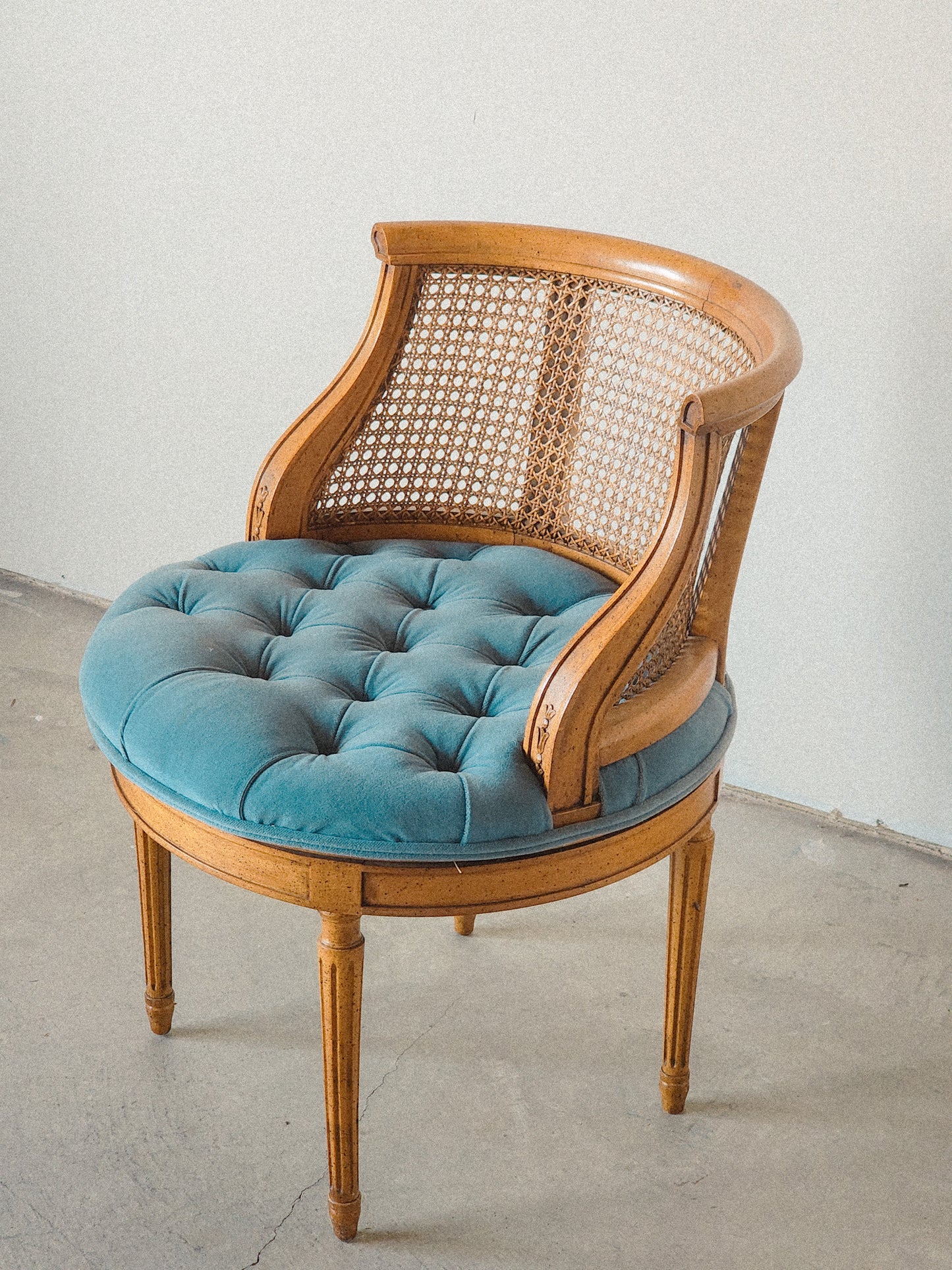 Vtg Swiveling Tufted Blue Caned Chair