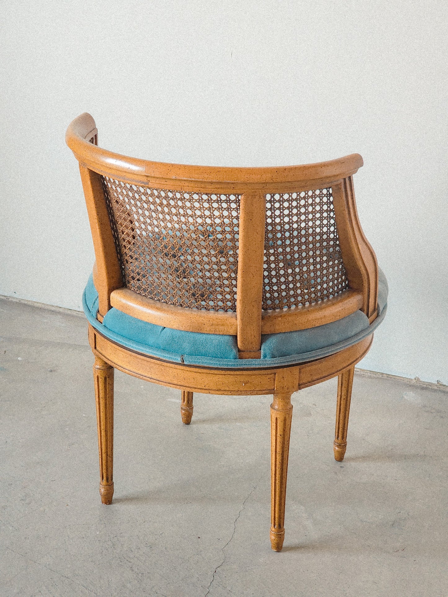 Vtg Swiveling Tufted Blue Caned Chair